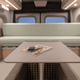 A photo of the living room in the RV that folds out into a bed.